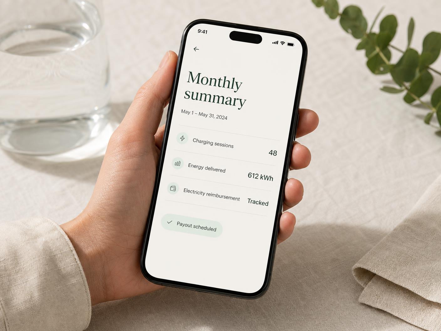 Phone showing a LetsVolt monthly summary with charging sessions, energy delivered and a scheduled host payout